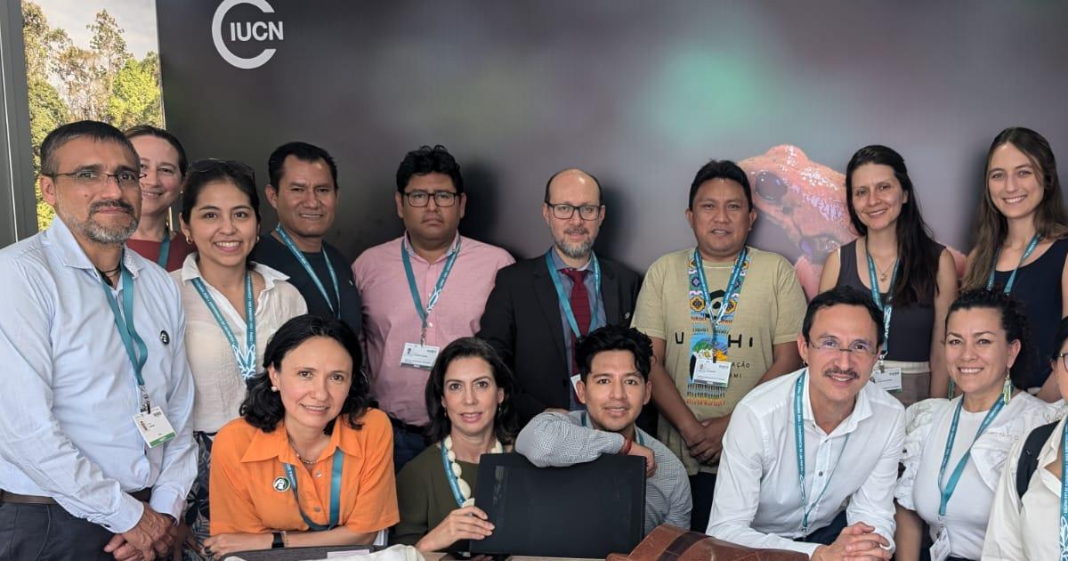 Marcos Orellana (back row center, in suit and tie) and Linnea Miller (back row, far right) at the COP16 event in Cali, Columbia.